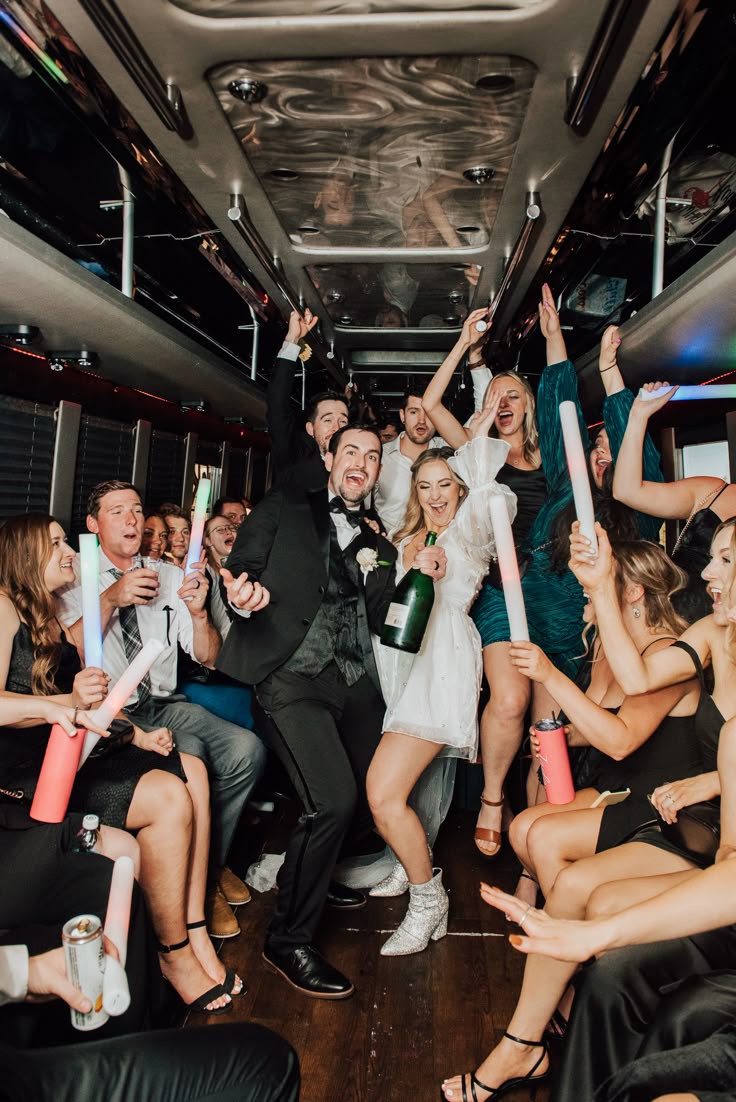 Couple and friends celebrating with champagne in limo bus
